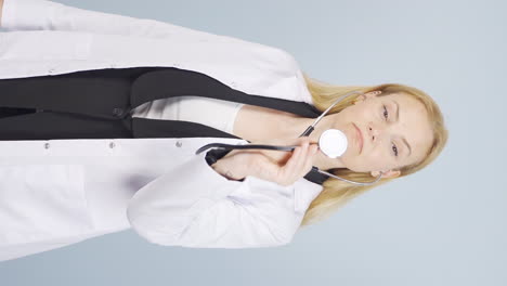Vertical-video-of-Doctor-listening-to-camera-with-stethoscope.